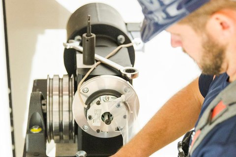 Technician working on mechanical elevator components
