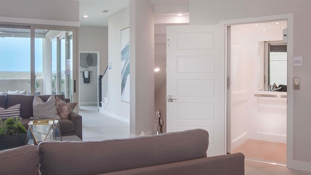 Open home elevator next to a modern living room