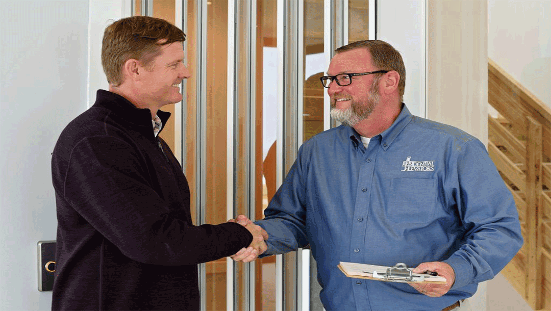Two men shaking hands and smiling