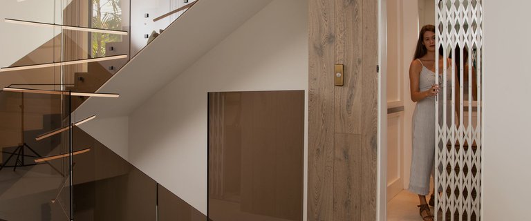Woman opening gate of home elevator