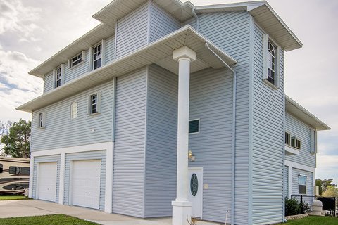 Tall light-blue house with vertical siding