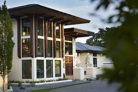 Modern multi-story home with tall vertical windows