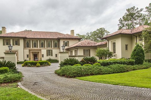Two story Mediterranean-style home with tile roof