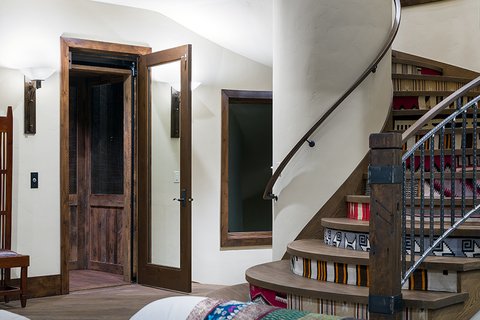 Home elevator at the bottom of a stairway