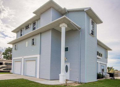 Tall light-blue house with vertical siding