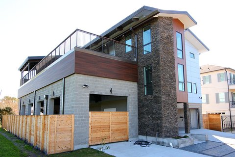 Two story modern home with stone facade
