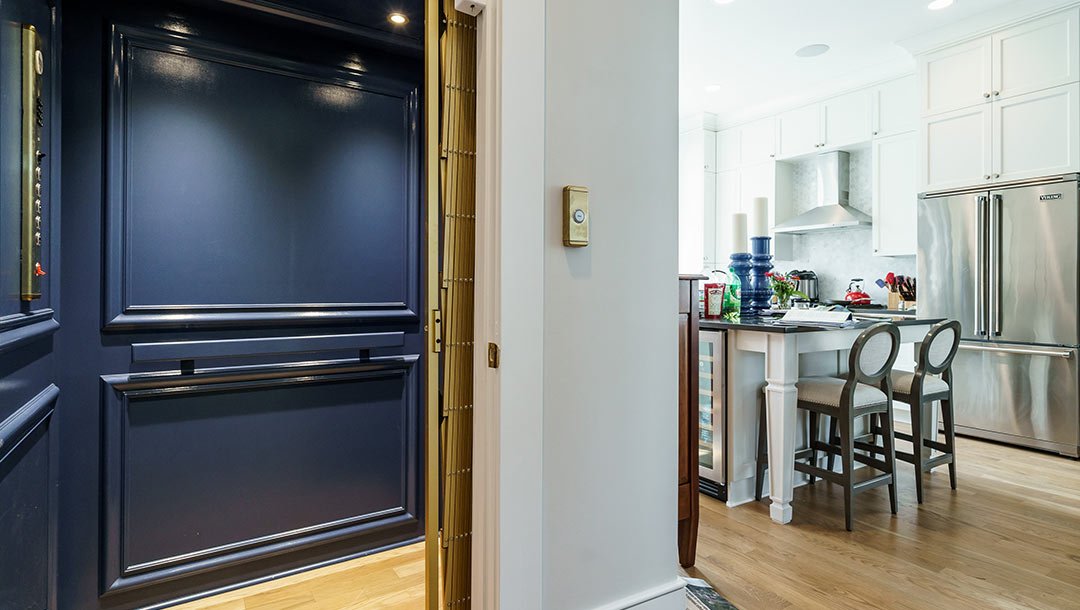 Elevator with blue interior off of kitchen
