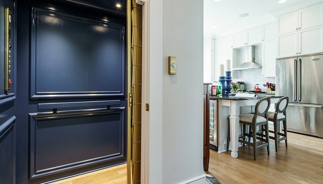 Elevator with blue interior off of kitchen